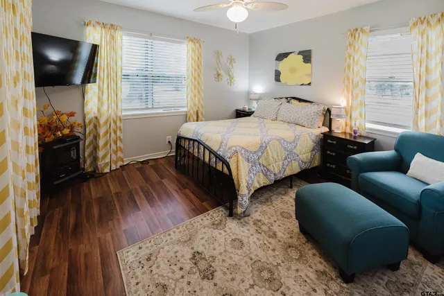 a bedroom with a bed and a chair