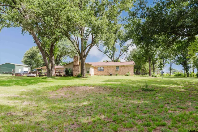 a front view of house with yard and green space