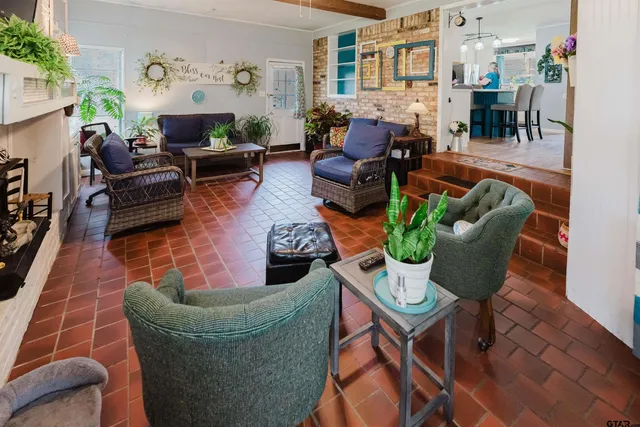 a living room with furniture potted plant and a fireplace