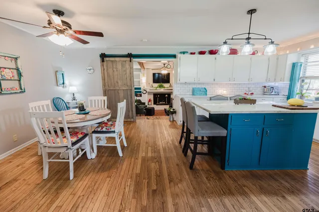 a dining room with a wooden table and chairs