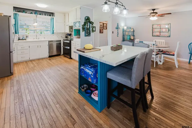 a large kitchen with a table and chairs