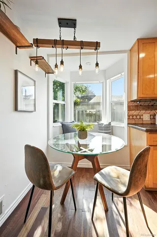 a dining room with furniture a chandelier and wooden floor