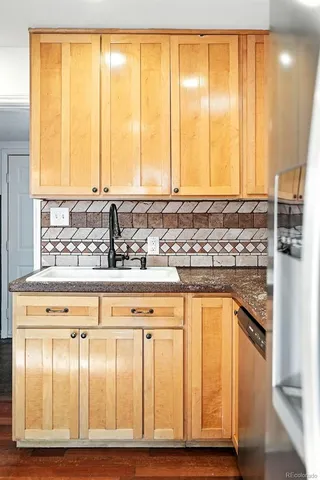 a view of kitchen with wooden floor and cabinets