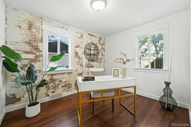 a workspace with furniture window and wooden floor