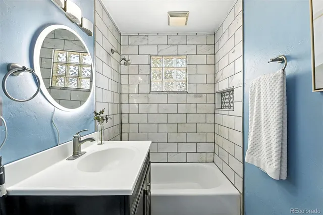a bathroom with a sink a toilet and a shower