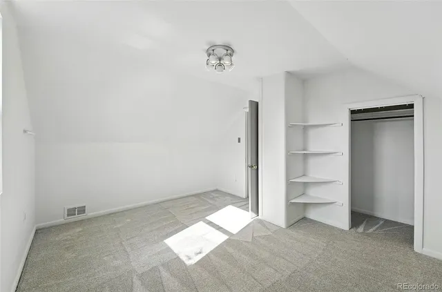 a view of an empty room and a window