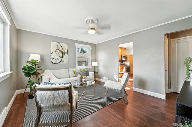 a living room with furniture and wooden floor