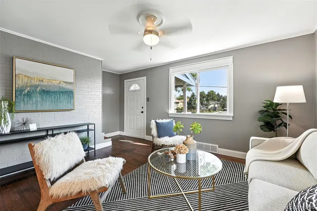 a living room with furniture a window and a lamp