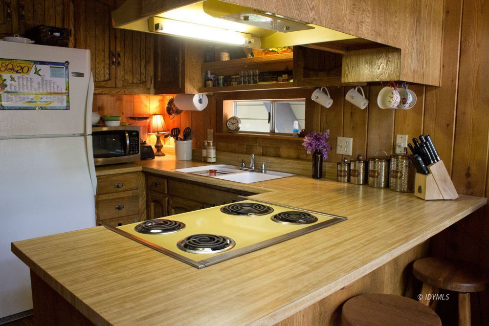 55425 Howland Road Idyllwild, CA 92549 - Photo 10 of 17 a kitchen with kitchen island a stove and a microwave