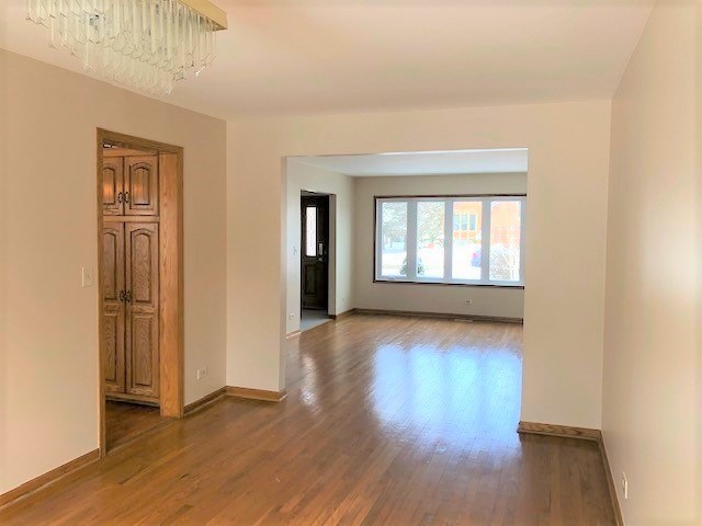 8725 West Sunset Road Niles, IL 60714 - Photo 5 of 15 wooden floor in an empty room with a window