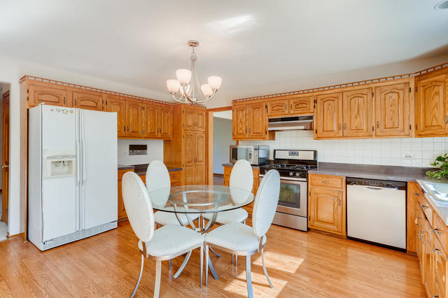 8725 West Sunset Road Niles, IL 60714 - Photo 7 of 15 a view of a dining room with furniture and wooden floor