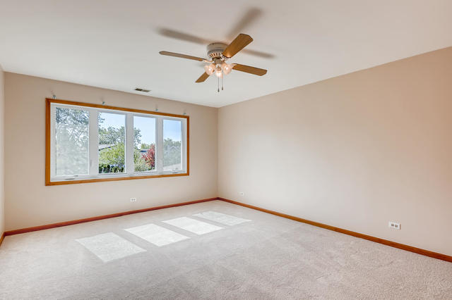 8725 West Sunset Road Niles, IL 60714 - Photo 9 of 15 an empty room with window and windows