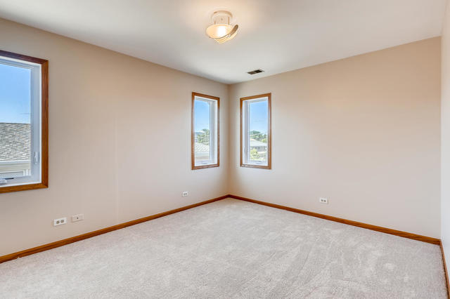 8725 West Sunset Road Niles, IL 60714 - Photo 10 of 15 an empty room with windows