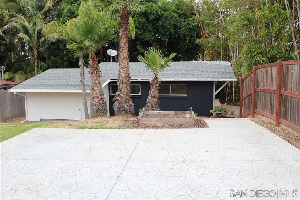 856 Capri Road Encinitas, CA 92024 - Photo 24 of 25 a view of a white house with a sink and yard