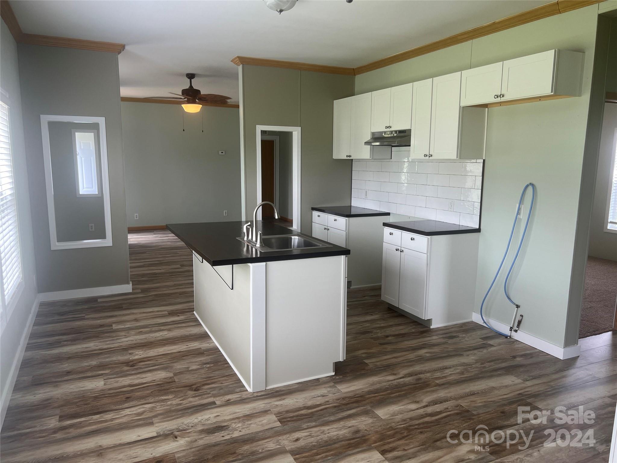 200 Olin Road Olin, NC 28660 - Photo 3 of 17 a kitchen with stainless steel appliances granite countertop a sink stove and refrigerator