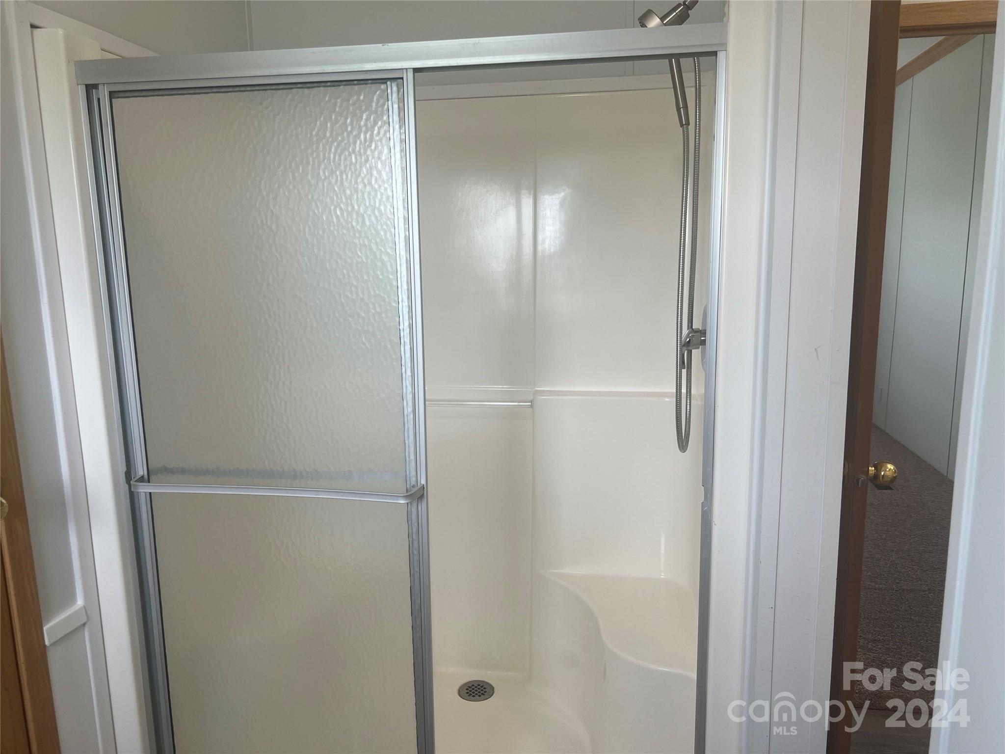 200 Olin Road Olin, NC 28660 - Photo 9 of 17 a bathroom with a glass shower door