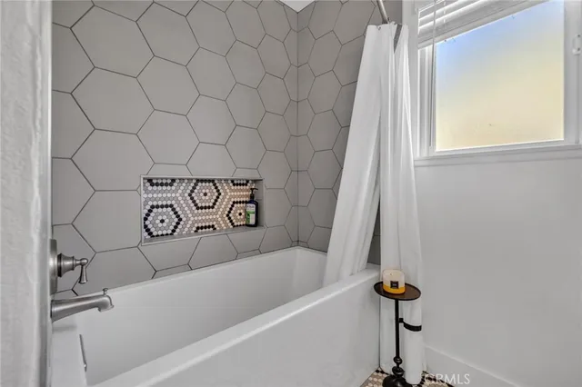 a view of a hallway with a livingroom and furniture