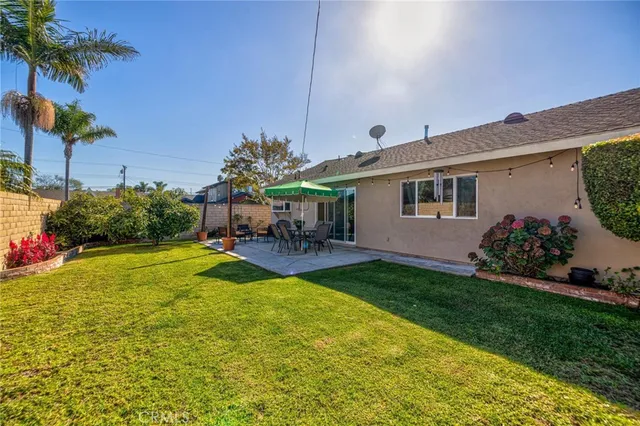 a view of a swimming pool with a table and chairs under an umbrella