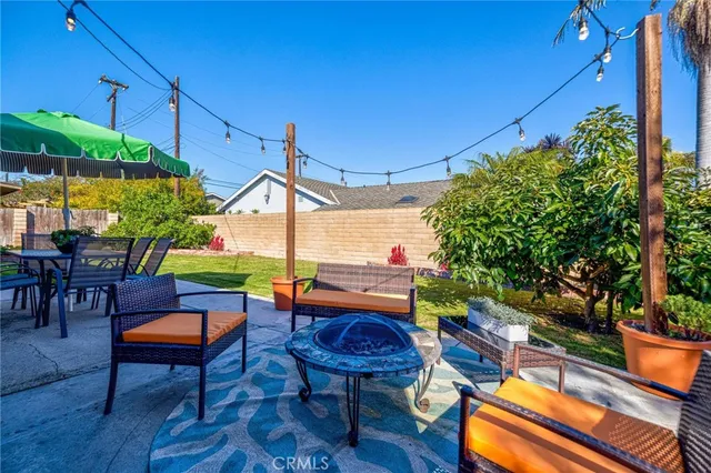 a view of an house with backyard outdoor seating and green space