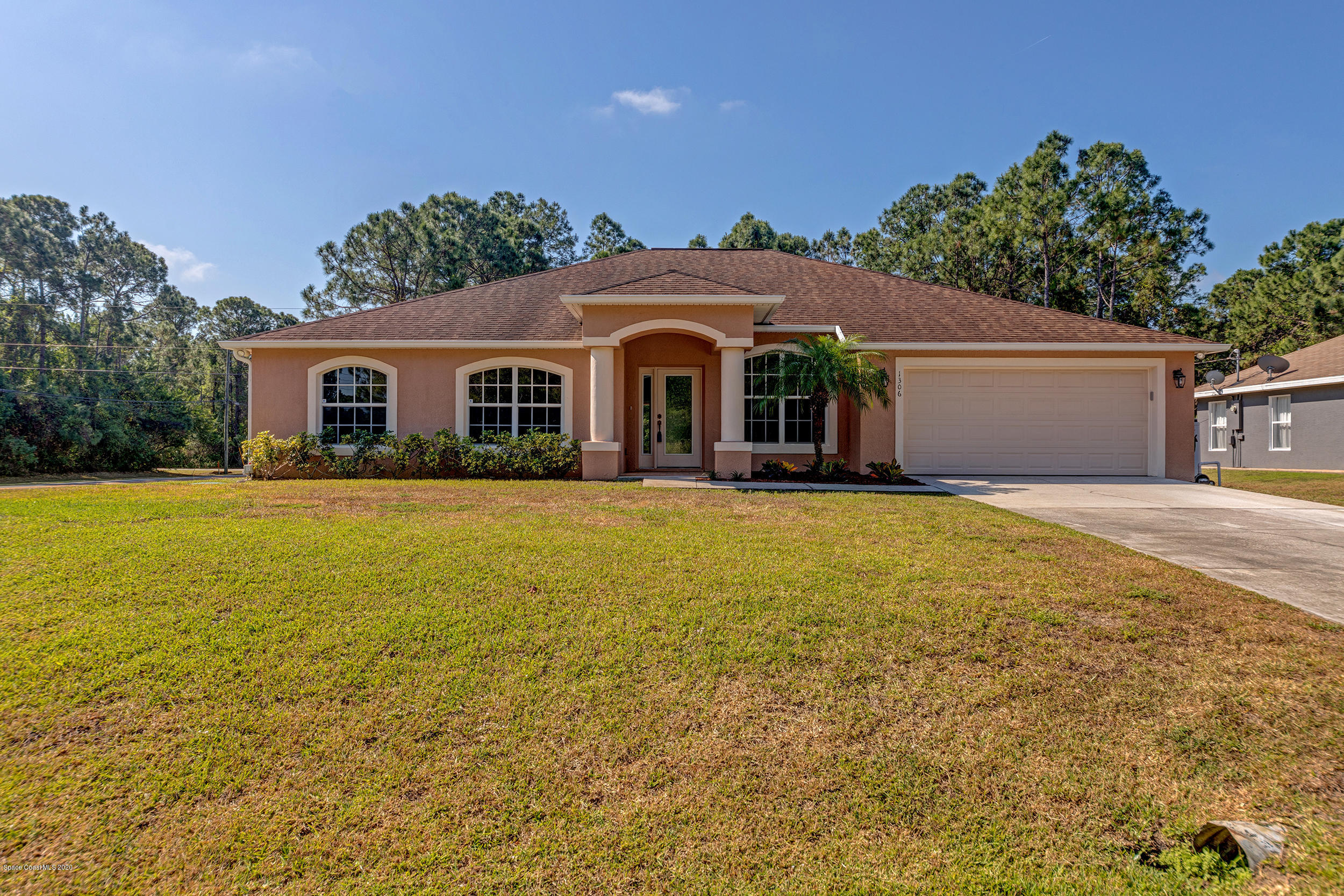 1306 Scranton Street Southwest Palm Bay, FL 32908 - Photo 1 of 36 a front view of house with yard and green space