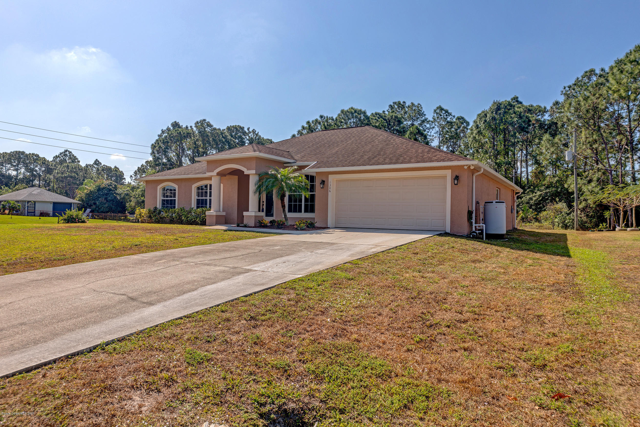 1306 Scranton Street Southwest Palm Bay, FL 32908 - Photo 2 of 36 a front view of a house with a yard