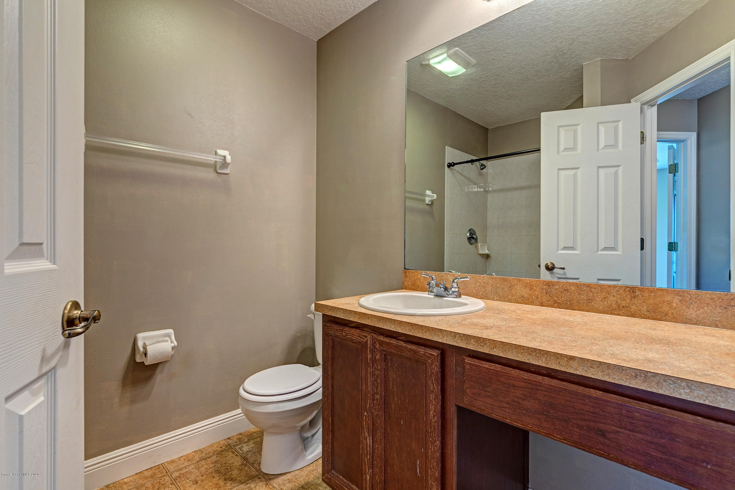 1306 Scranton Street Southwest Palm Bay, FL 32908 - Photo 11 of 36 a bathroom with a granite countertop sink toilet and shower