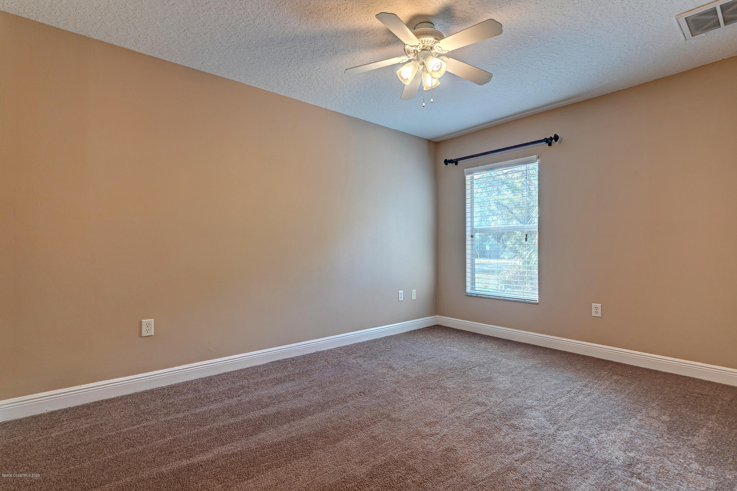 1306 Scranton Street Southwest Palm Bay, FL 32908 - Photo 14 of 36 an empty room with a window and a fan