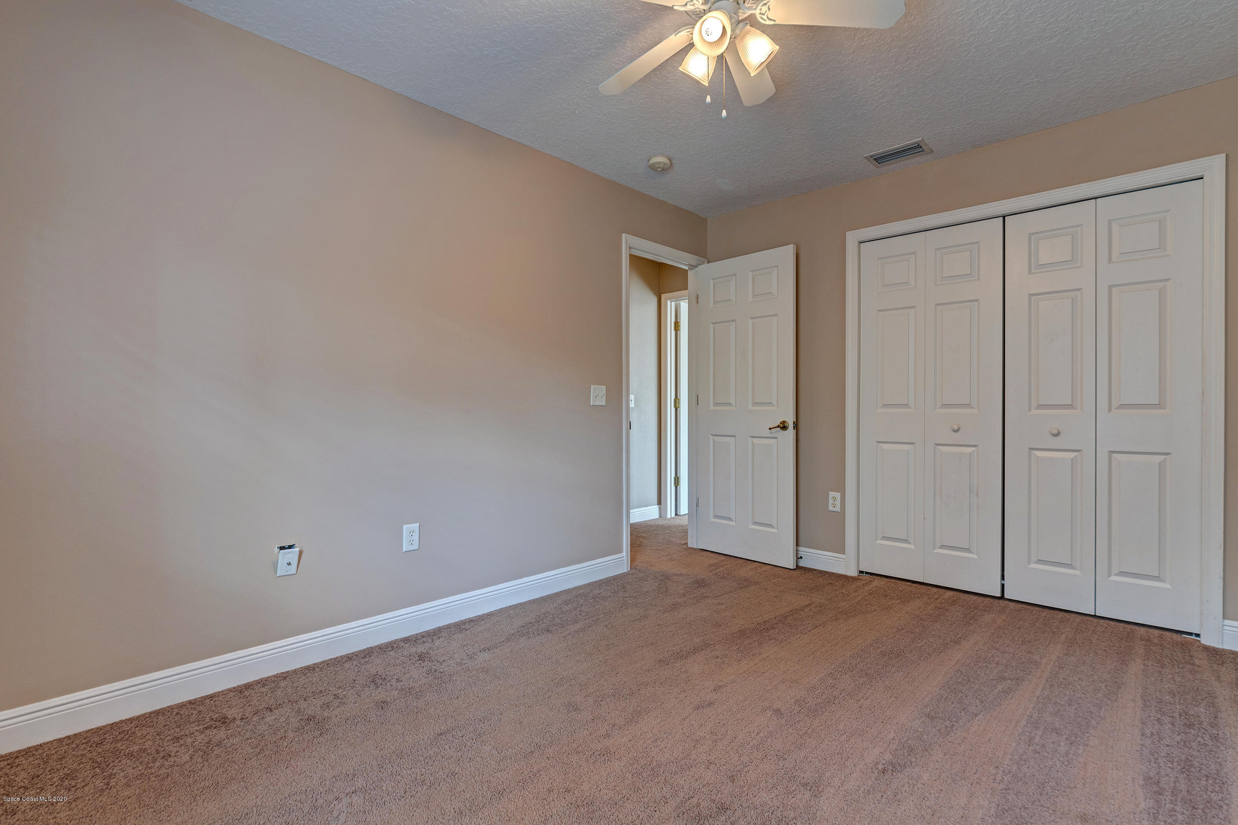 1306 Scranton Street Southwest Palm Bay, FL 32908 - Photo 15 of 36 a view of an empty room and chandelier fan