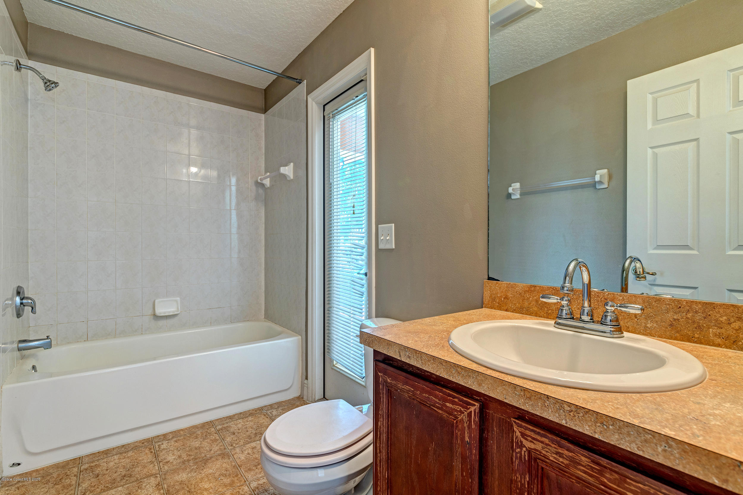 1306 Scranton Street Southwest Palm Bay, FL 32908 - Photo 16 of 36 a bathroom with a sink a toilet and shower