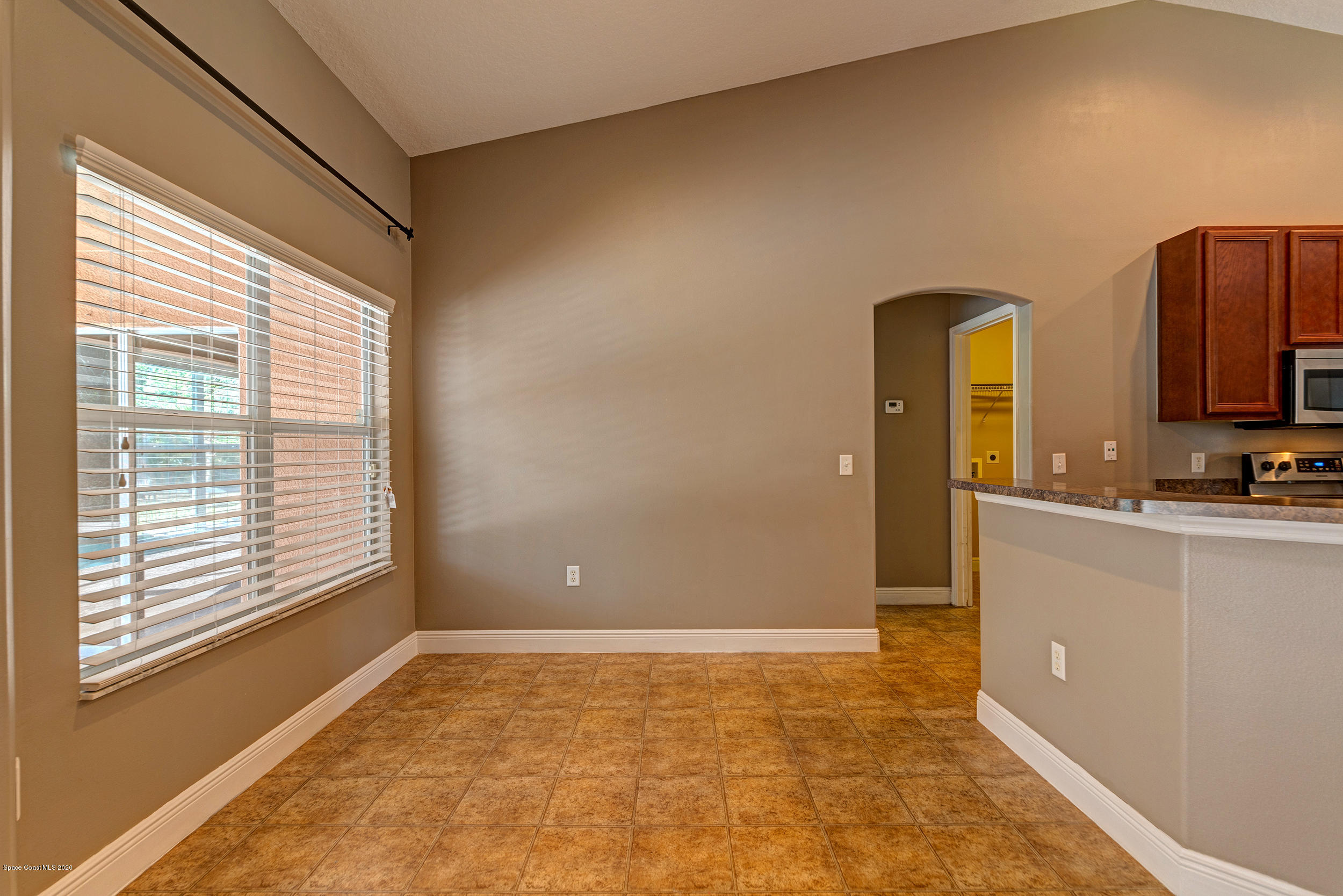 1306 Scranton Street Southwest Palm Bay, FL 32908 - Photo 20 of 36 a view of an empty room with window and a kitchen