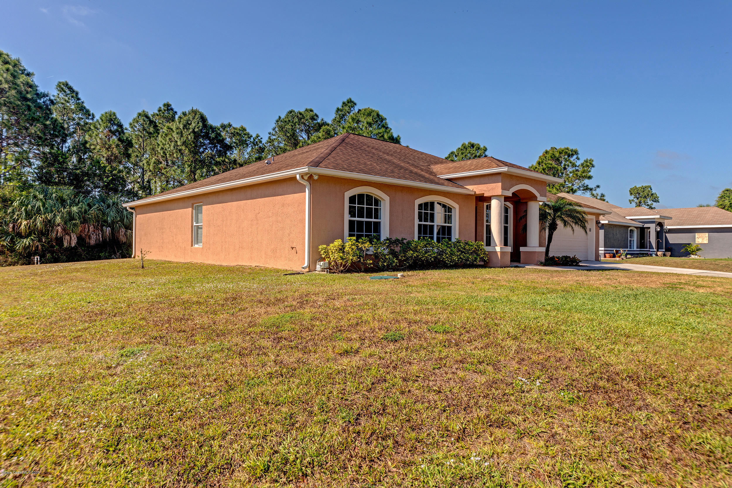 1306 Scranton Street Southwest Palm Bay, FL 32908 - Photo 3 of 36 a front view of a house with a garden