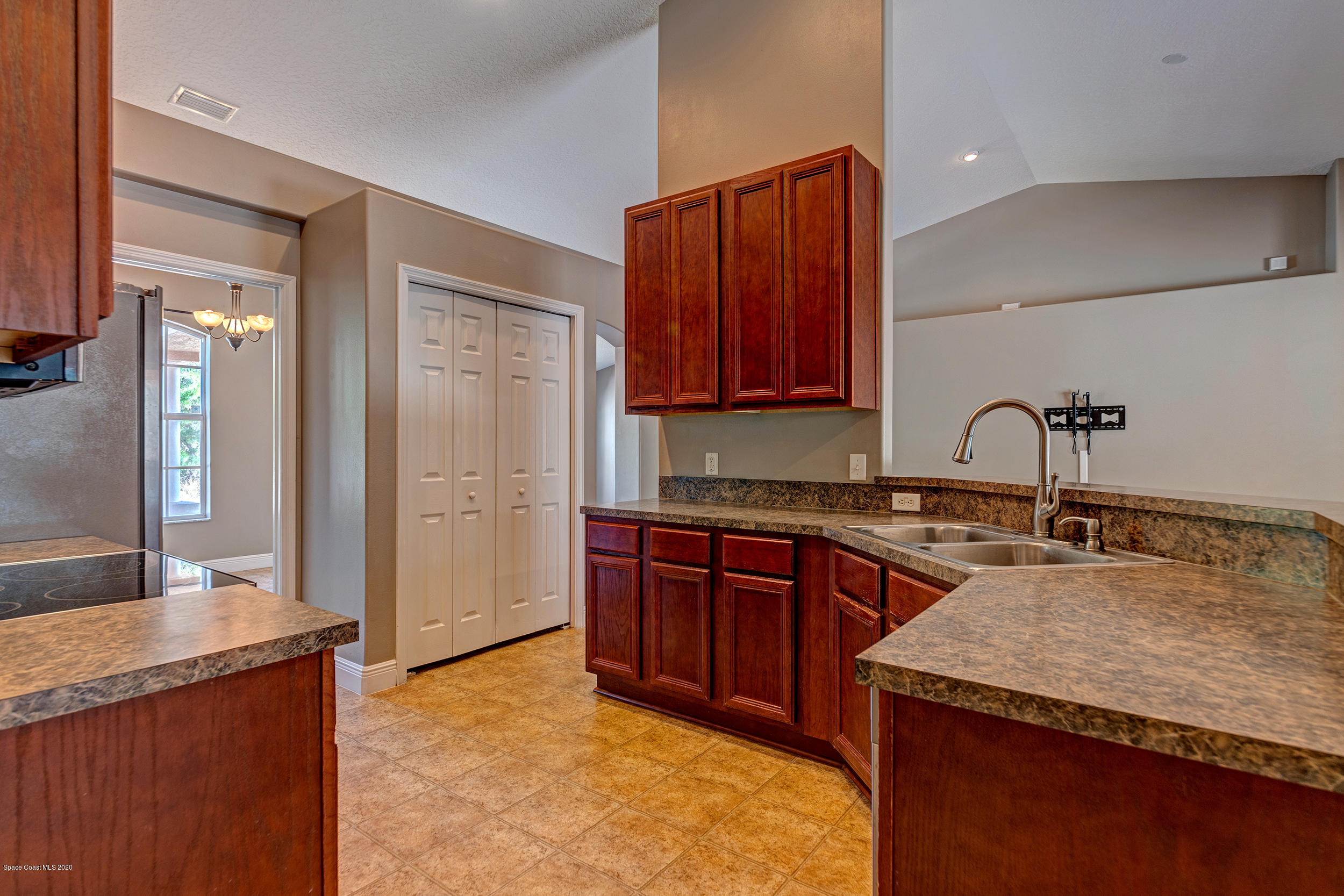 1306 Scranton Street Southwest Palm Bay, FL 32908 - Photo 22 of 36 a kitchen with stainless steel appliances granite countertop a sink stove and refrigerator