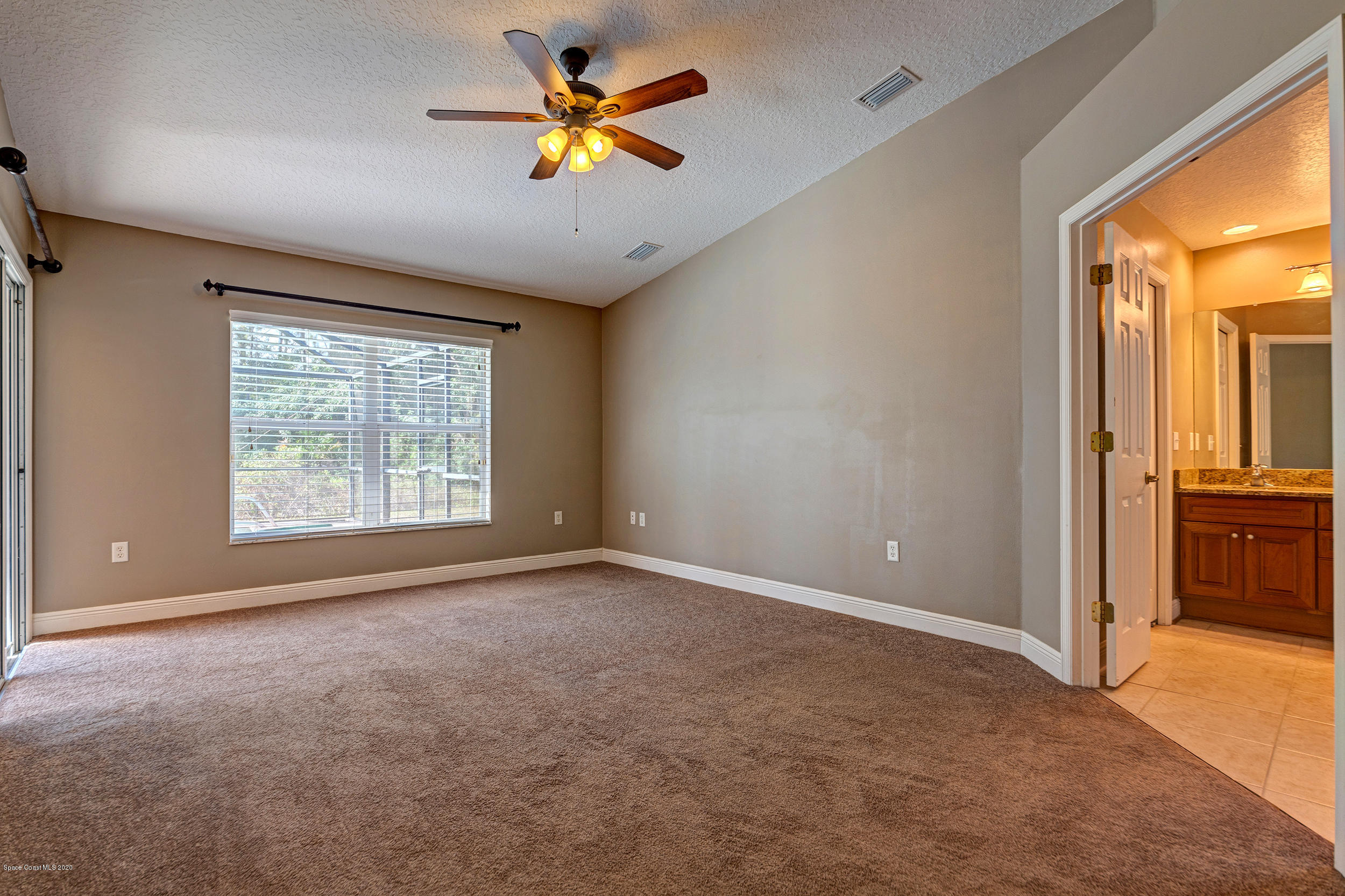 1306 Scranton Street Southwest Palm Bay, FL 32908 - Photo 26 of 36 an empty room with a window and a ceiling fan