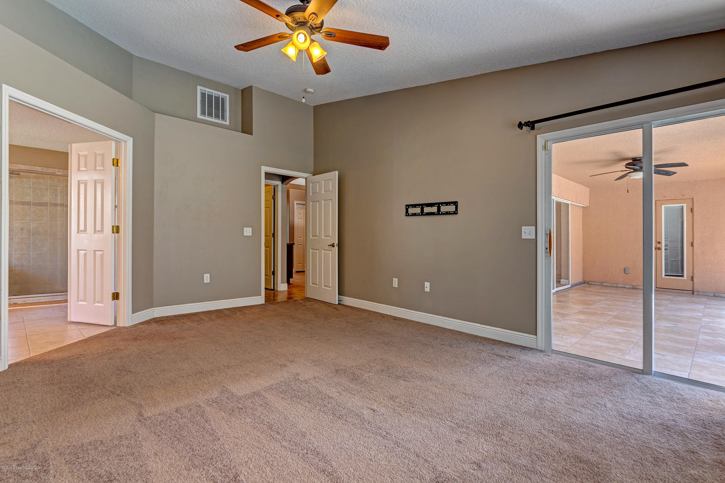 1306 Scranton Street Southwest Palm Bay, FL 32908 - Photo 28 of 36 an empty room with closet and a chandelier fan