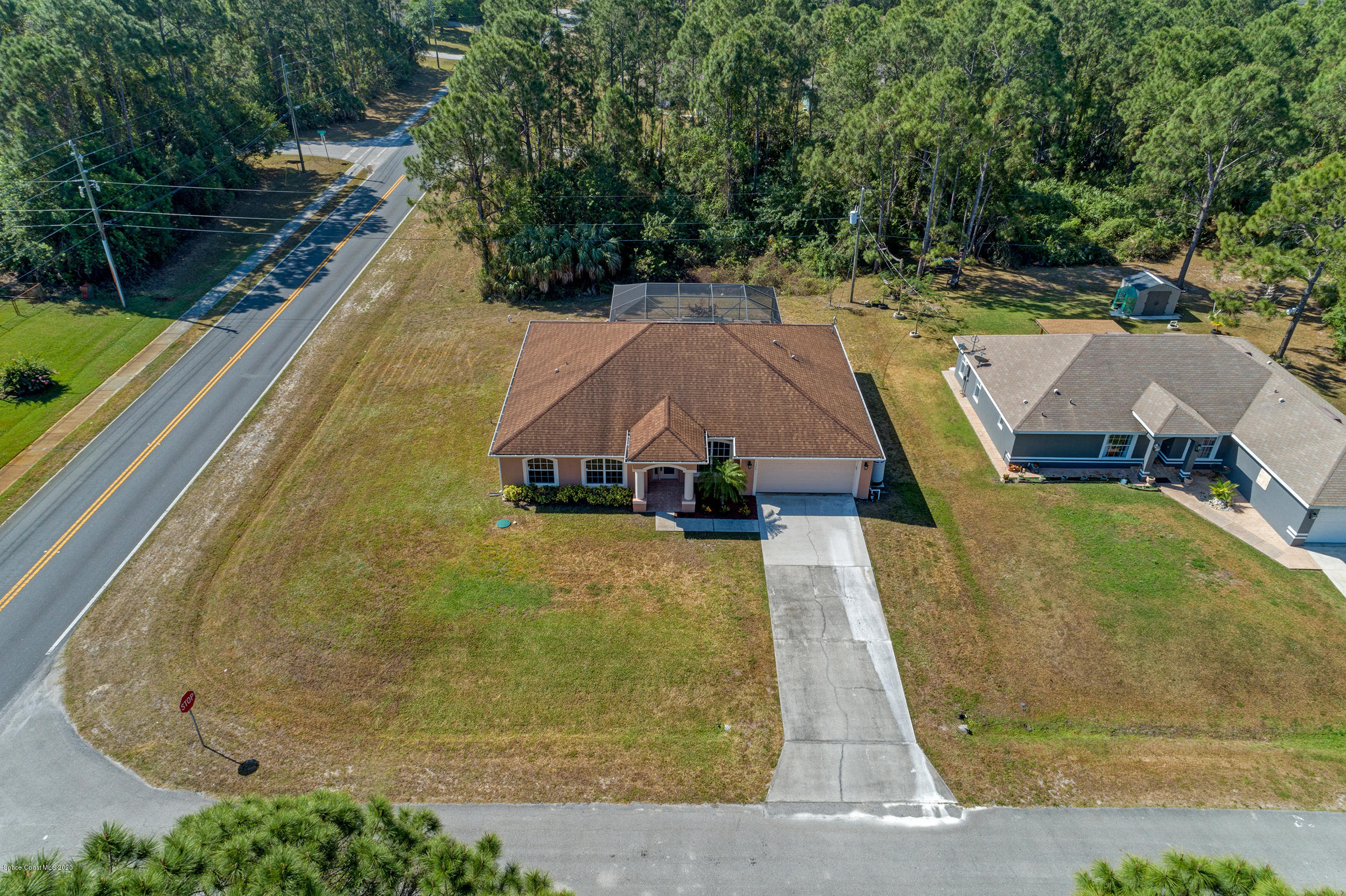 1306 Scranton Street Southwest Palm Bay, FL 32908 - Photo 34 of 36 a aerial view of a house with swimming pool and large trees