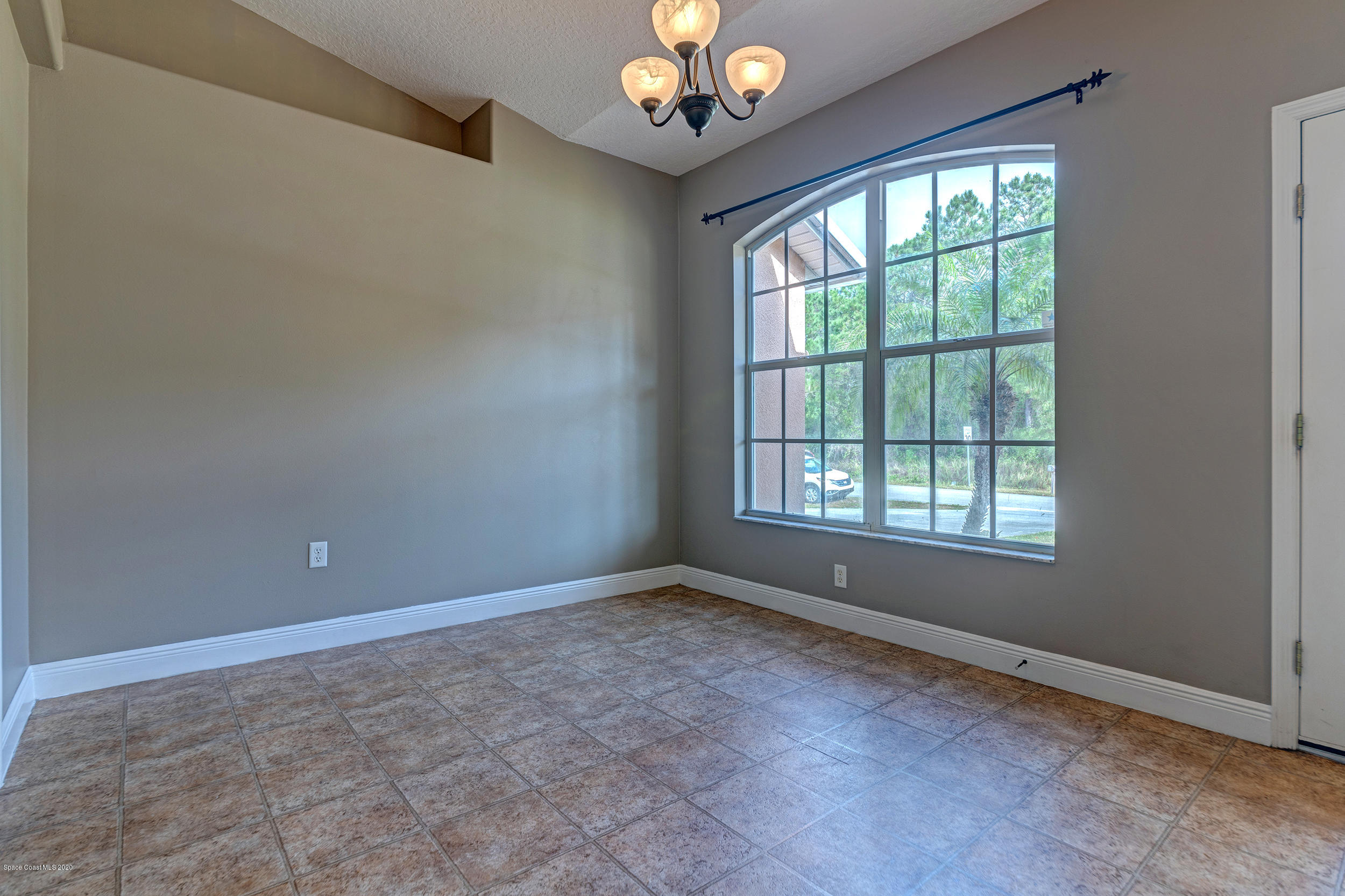 1306 Scranton Street Southwest Palm Bay, FL 32908 - Photo 5 of 36 a view of an empty room with a window