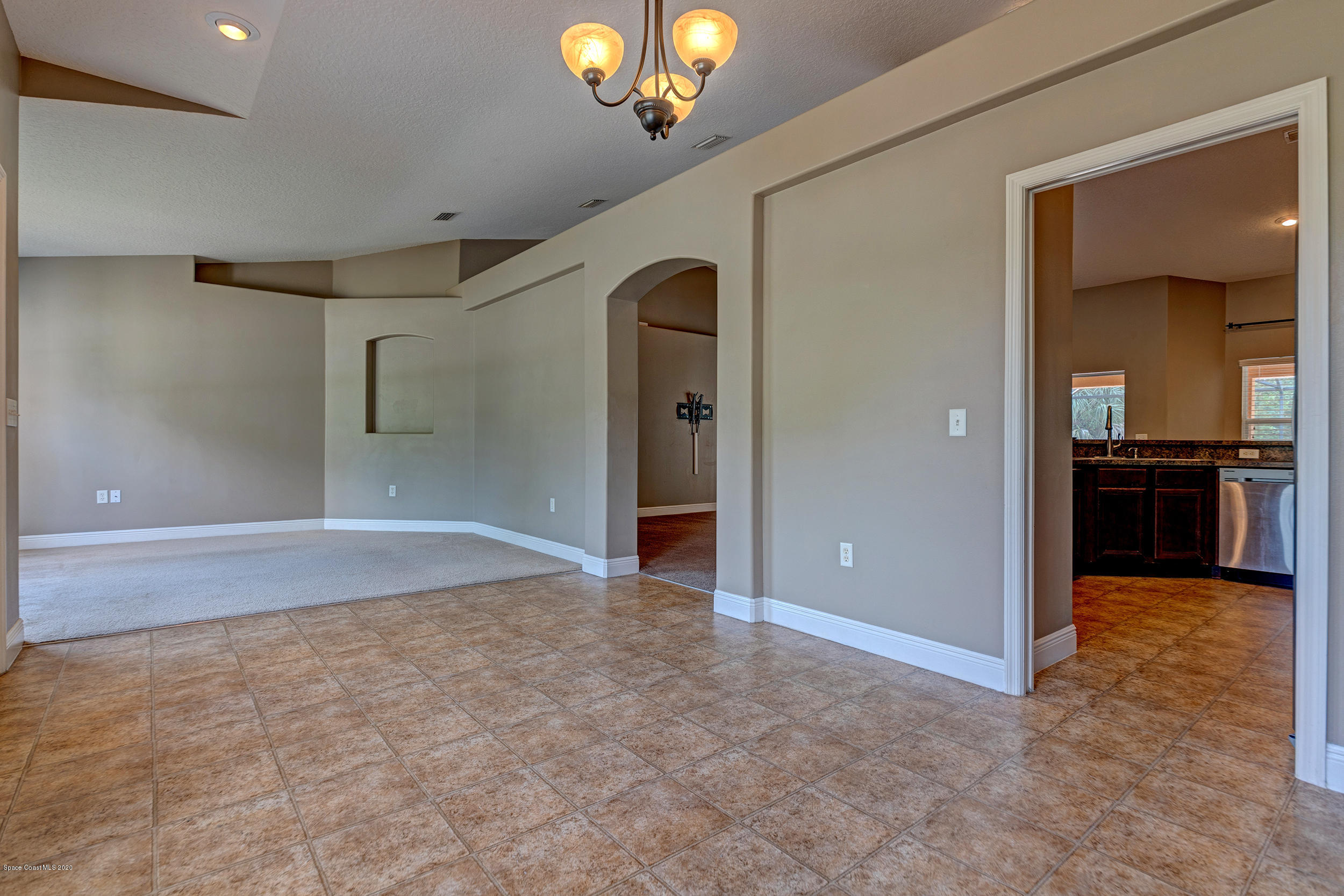 1306 Scranton Street Southwest Palm Bay, FL 32908 - Photo 6 of 36 wooden floor in an empty room with a chandelier