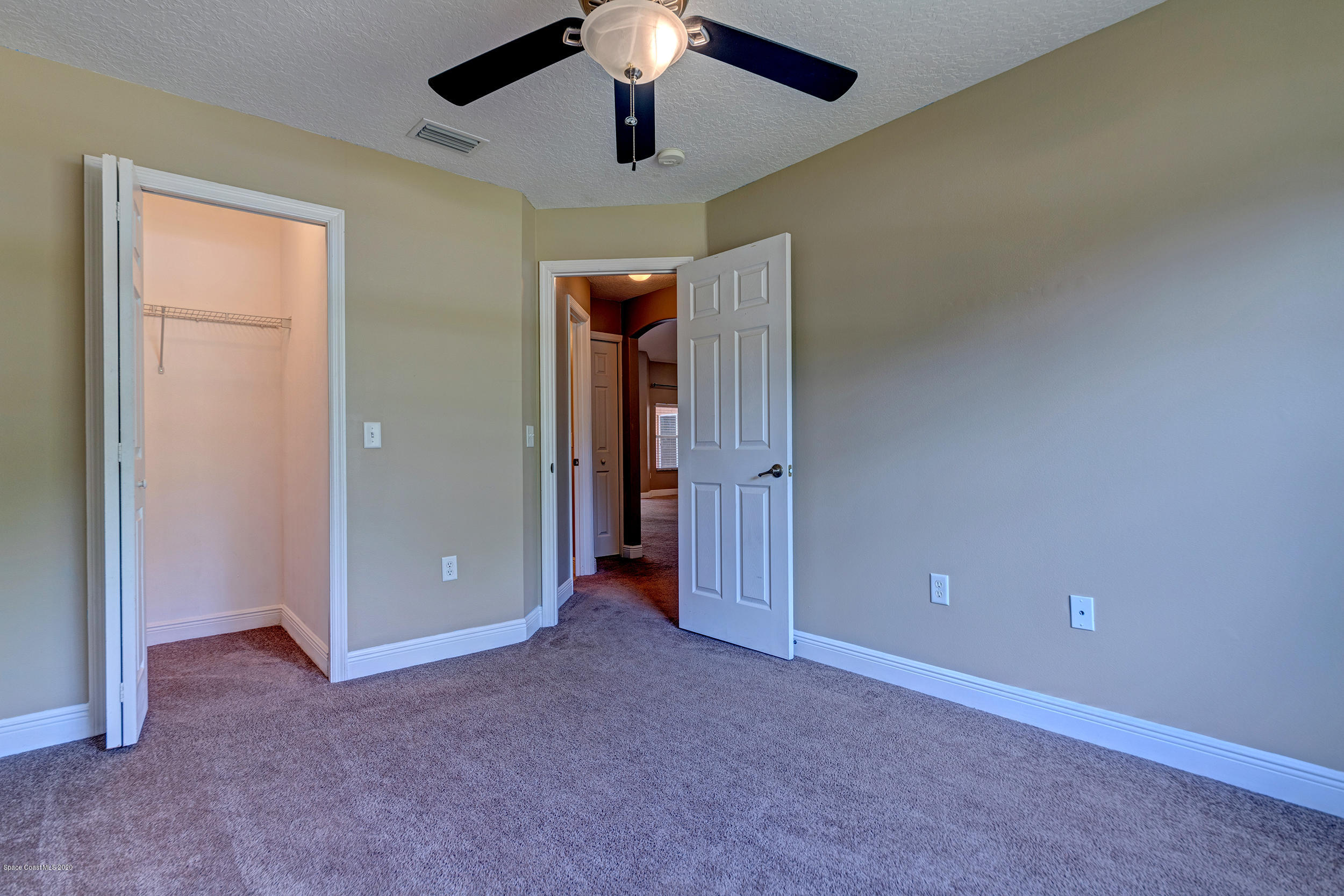 1306 Scranton Street Southwest Palm Bay, FL 32908 - Photo 10 of 36 an empty room with a ceiling fan and a chandelier fan