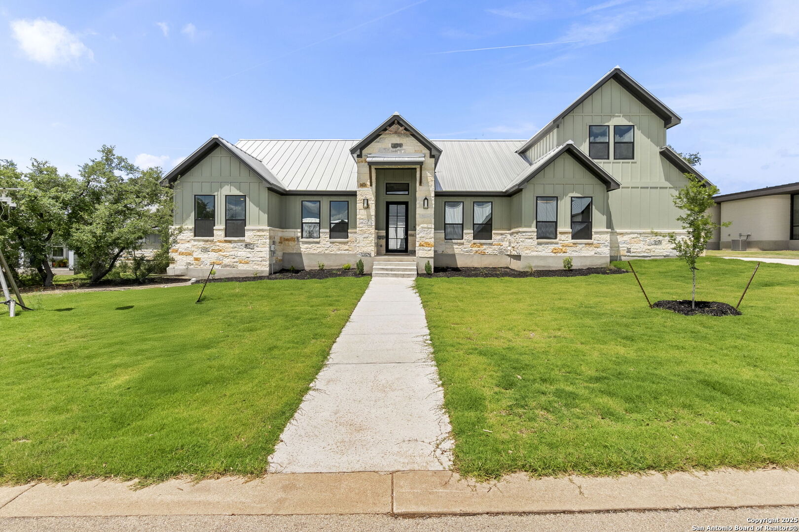 32 Peace Pipe Wimberley, TX 78676 - Photo 1 of 9 a front view of a house with a yard and trees