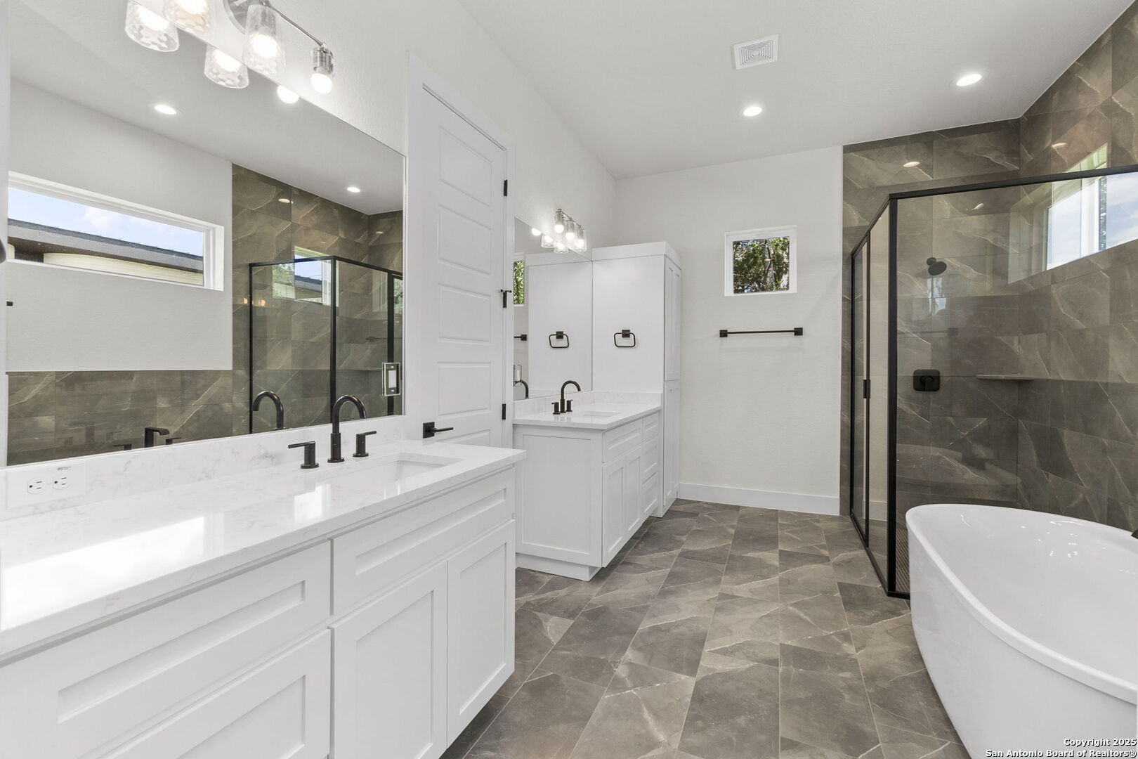 32 Peace Pipe Wimberley, TX 78676 - Photo 9 of 9 a spacious bathroom with a bathtub shower sink and mirror