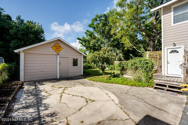 5116 Sunderland Road Jacksonville, FL 32210 - Photo 29 of 33 a view of a house with a yard and potted plants