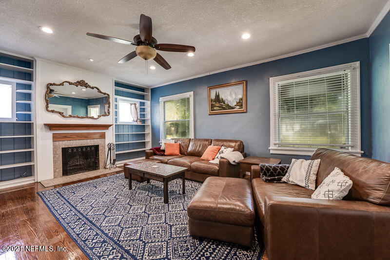 5116 Sunderland Road Jacksonville, FL 32210 - Photo 9 of 33 a living room with furniture and a fireplace