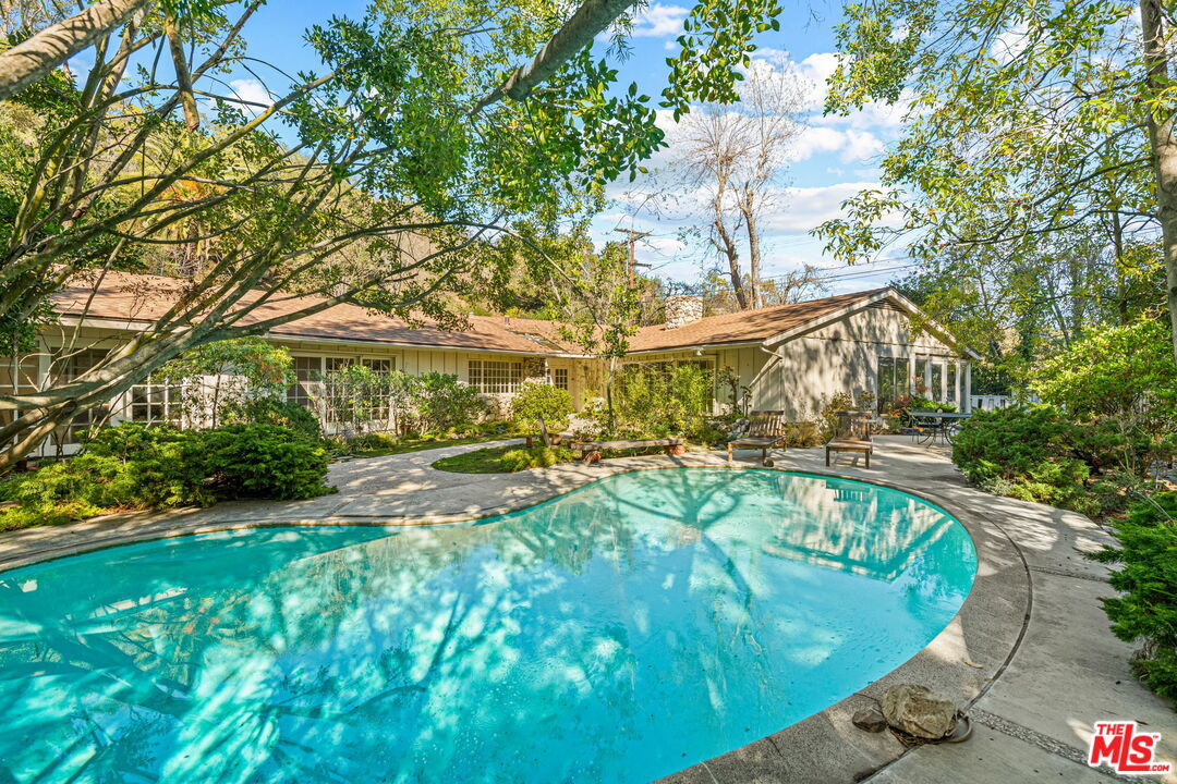 a swimming pool with outdoor seating and yard
