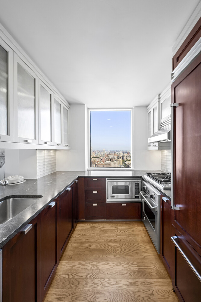 2628 Broadway, Unit 34 Manhattan, NY 10025 - Photo 7 of 9 a large kitchen with stainless steel appliances granite countertop a stove and a sink