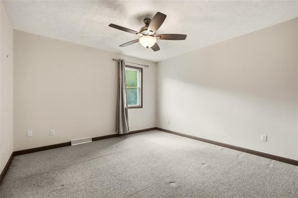 8517 Wittmer Road Pittsburgh, PA 15237 - Photo 24 of 46 an empty room with a ceiling fan and window