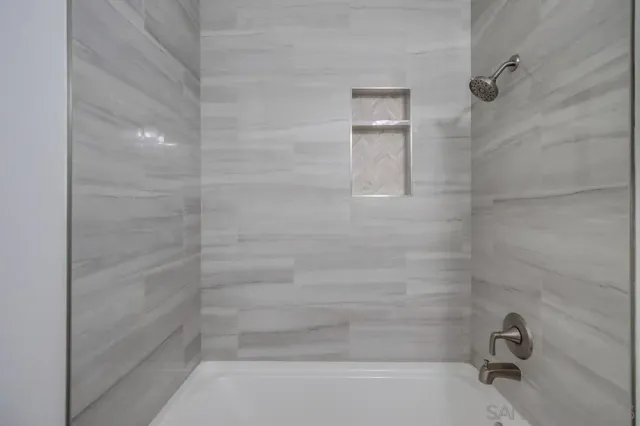 a bathroom with a sink toilet vanity and tub