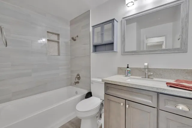 a bathroom with a sink a toilet and bathtub