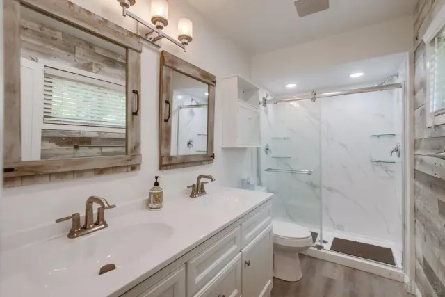 a backyard of a house with table and chairs plants and large tree