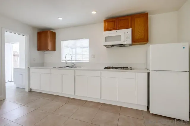 an aerial view of a house with swimming pool and outdoor seating