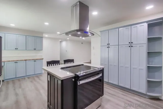 a kitchen with a stove a refrigerator and a sink